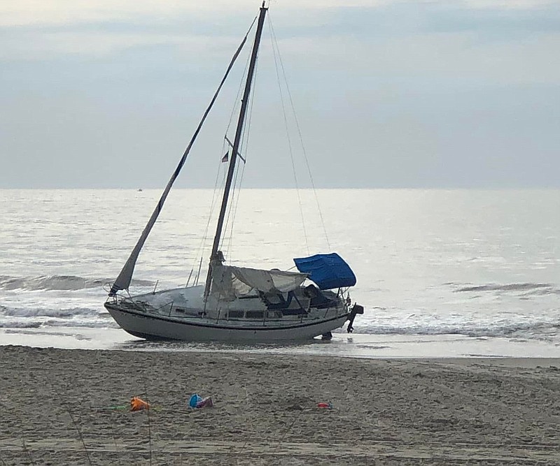 The sailboat struck a jetty and beached at Ninth Street.  (Photo courtesy of Facebook post by Ken Wendi Overby)