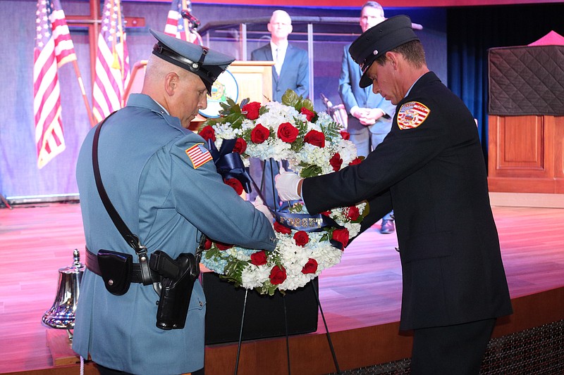 Ocean City Patrolman Jeff Doto, left, and Ocean City Firefighter Brian Warley place the wreath in front of the stage at the City Tabernacle during the 9/11 ceremony.
