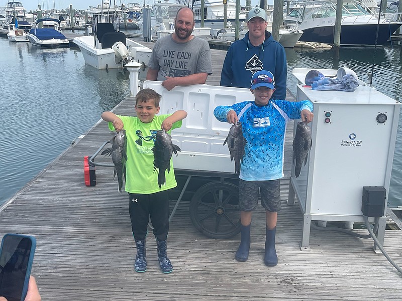 Young anglers show off the sea bass they caught during a Mighty Heron Charters trip. (Photo courtesy of Mighty Heron Charters)