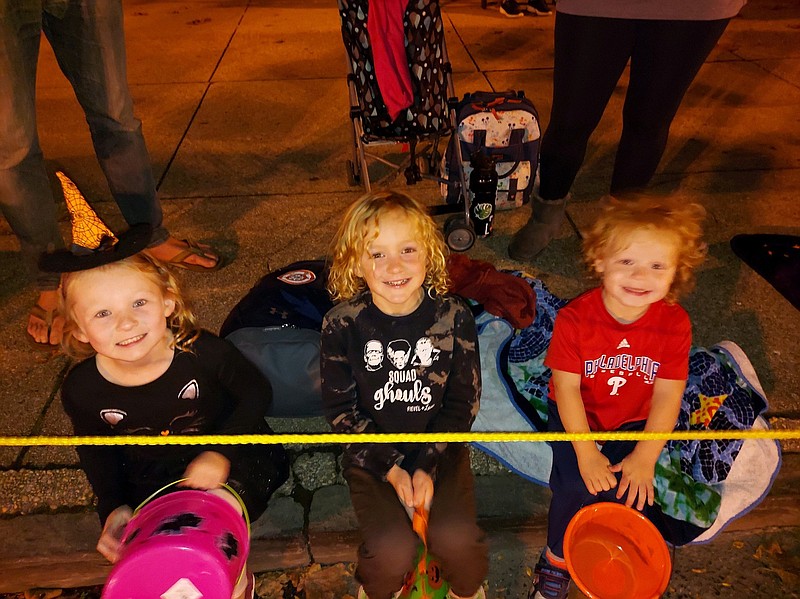 Aberly Mroz, 6, Sutton Swerline, 4, and Aceson Mroz, 2, have their candy buckets ready to catch some treats.