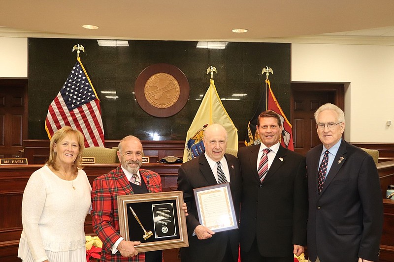 Commissioners Marie Hayes and Leonard Desiderio during a ceremony for former director Gerald M. Thornton, with then Commissioner-elect Andrew J. Bulakowski, and Commissioner Jeffrey Pierson pictured with gavel.