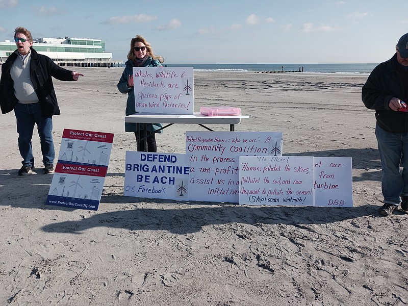 Signs displayed at the news conference reflect opposition to the proposed offshore wind farms off the New Jersey coast. 