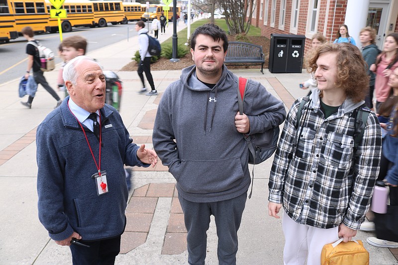 Investment Club members Luke Monichetti, 17, center, of Sea Isle, and Aidan Fasy, 18, of Ocean City, chat with Interim Assistant High School Principal Kenneth Silver. 