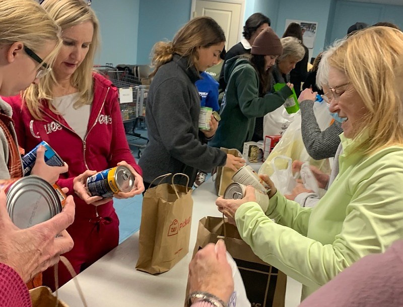 Volunteers help sort donated food at the Ecumenical Council's Food Cupboard inside St. Peter's United Methodist Church in 2023. (Photo courtesy of Regina Ralston)