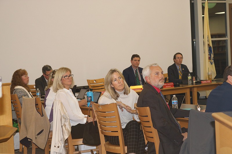 Newly-elected Board of Education members Robin Shaffer, Catherine Panico, middle, and Liz Nicoletti listen to speakers.