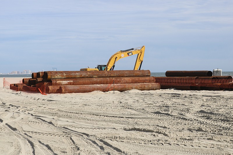 Some of the massive pipes and construction equipment used for the beachfill project still must be removed.