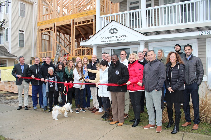 City officials, Chamber of Commerce representatives and local dignitaries join Dr. Jason Chew and his family for the ribbon-cutting ceremony. (Photo courtesy of Ocean City Regional Chamber of Commerce)