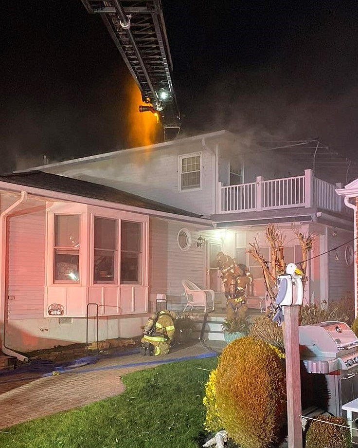 Firefighters extinguish a fire at a home on Spruce Road in March. (Photo courtesy of Ocean City Firefighters Association)