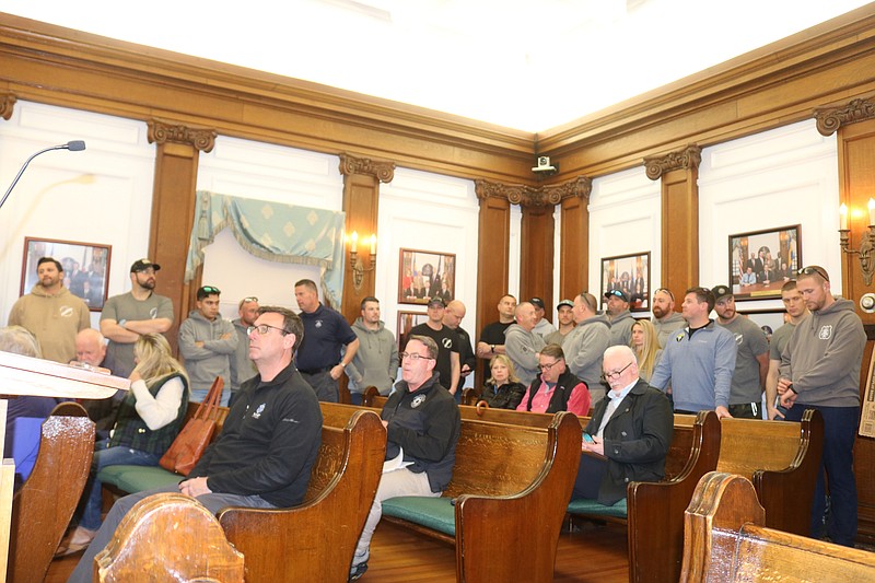 Ocean City police officers stand in the back of the Council chambers in a show of unity in their contract negotiations with the city in March.