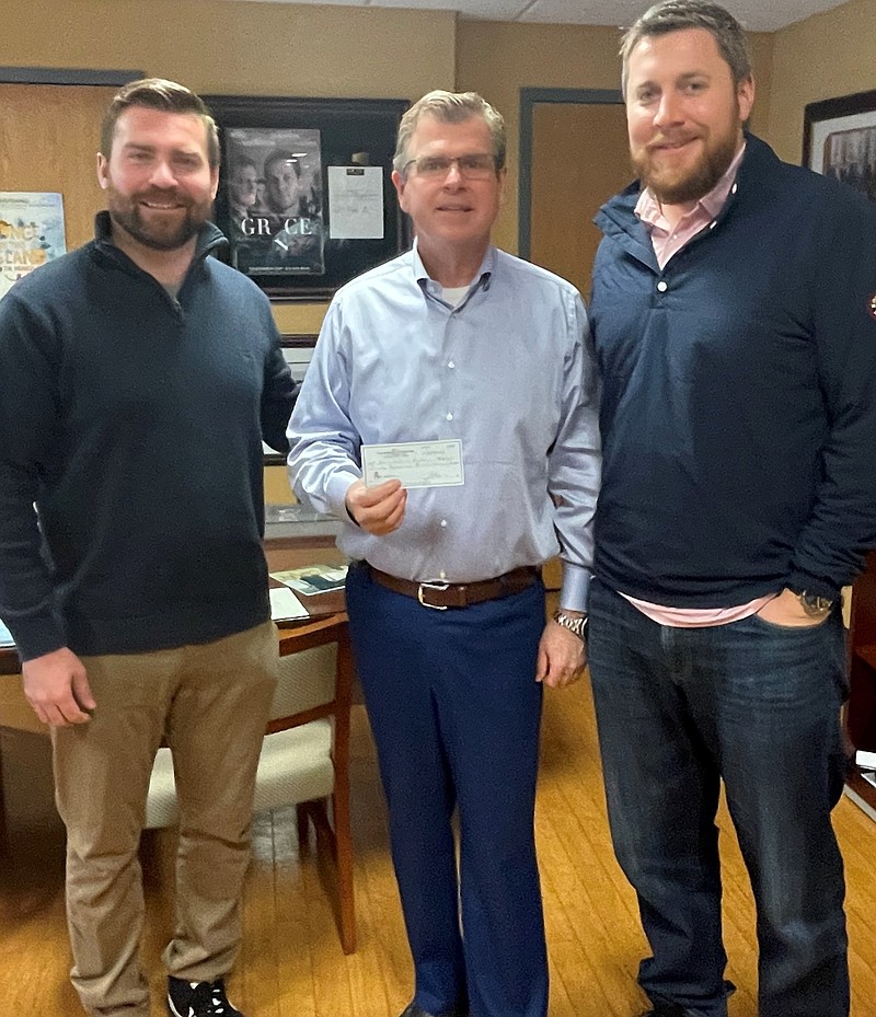 Shore Medical Center Chief Financial Officer David Hughes, center, accepts a donation from Jason Dugan, left, and David Beyel, Jr. (Photo courtesy of Shore Medical Center)