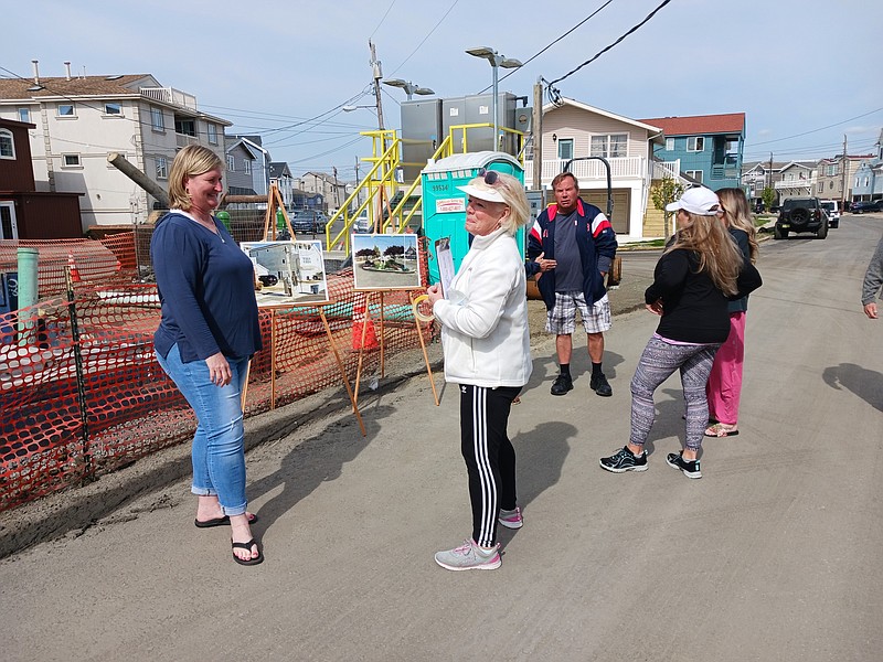 Homeowners stand in front of the construction zone that is one of the first things residents and visitors see when entering West 17th Street.