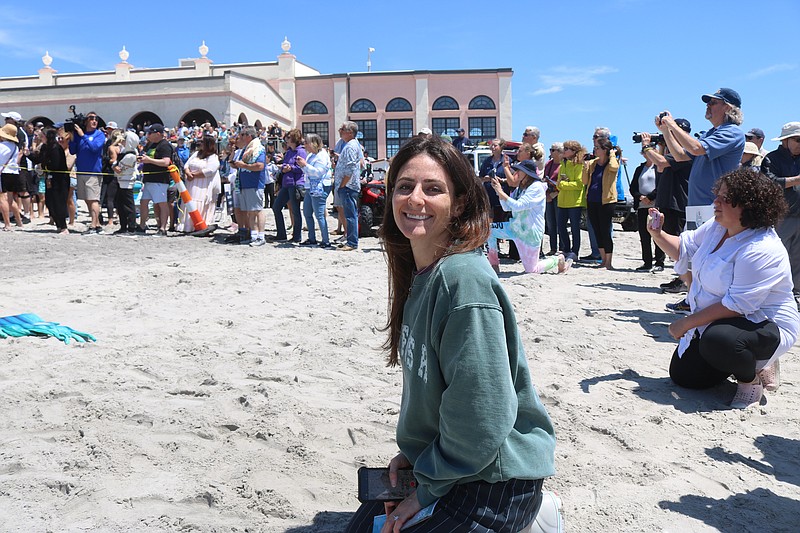 President of the Downtown Merchants Association Caitlin Quirk flashes a smile.