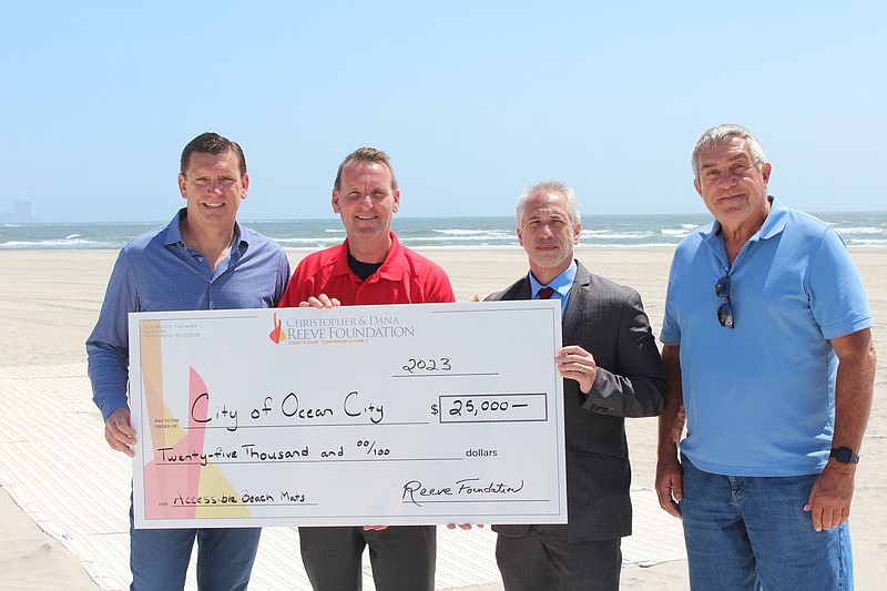 Christopher &amp; Dana Reeve Foundation Board of Directors member Tom Londres, Ocean City Mayor Jay Gillian, Foundation Director of the Quality of Life Grants Program Mark Bogosian, and Ocean City Public Works Manager Mike Rossbach stand on new beach mats purchased with foundation grant money. (Photos courtesy of Ocean City)