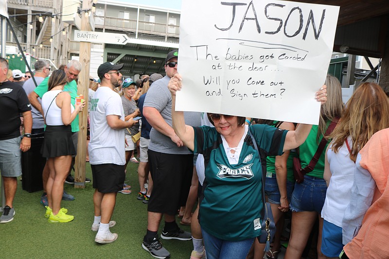 Joanne Kowall, of Media, Pa., holds up a handmade sign to try to get Jason Kelce’s attention.