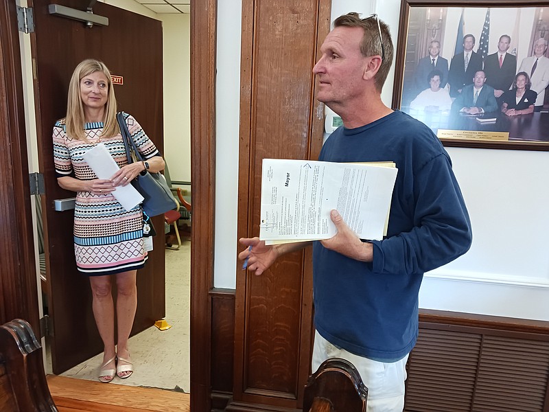 Mayor Jay Gillian speaks to reporters after the emergency Council meeting, while City Solicitor Dorothy McCrosson listens.