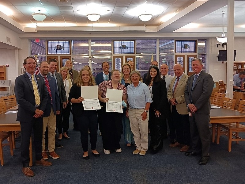 Student representatives Lauren Knopp, left, and Isabello Pero, display their certificates. Student representative Christian Ganter was unable to attend.