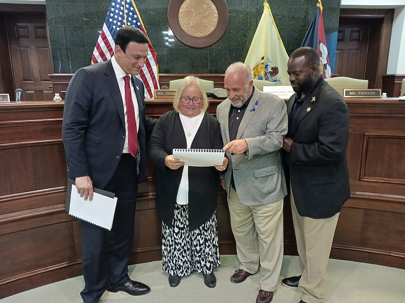 From left, state Sen. Michael Testa, Cape May County Tourism Director Diane Wieland, Cape May County Board of Commissioners Director Leonard Desiderio and state Assemblyman Antwan McClellan look at the 2022 tourism report.