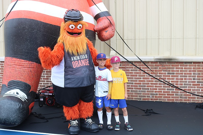 Friends Michael Doud, left, and Max Ashleigh, of Springfield, Pa., get their photos with Gritty.