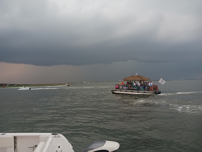 When the skies turned ominous and the lighting strikes drew nearer, boats were called to shore until the storm ended during the 68th annual Night in Venice boat parade.