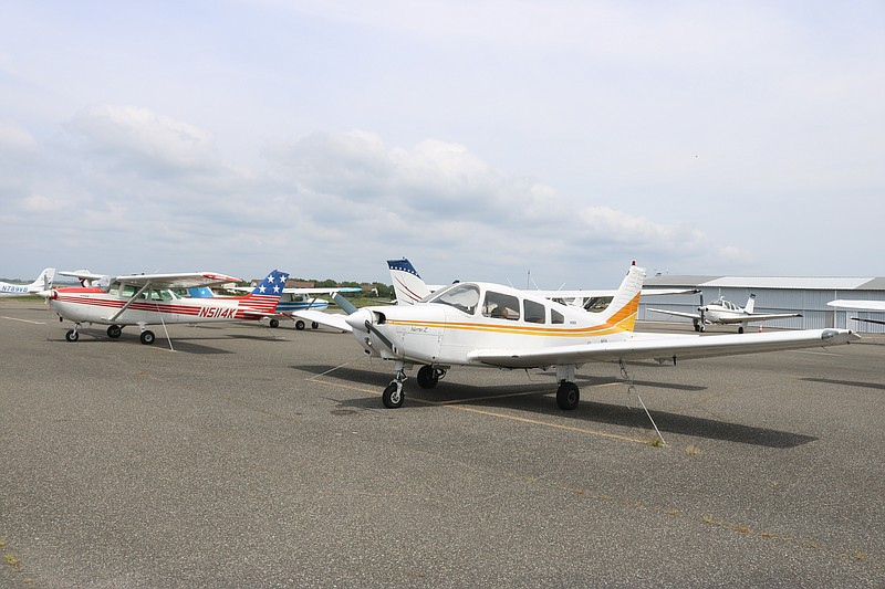 Planes line the tarmac on a summer weekend.