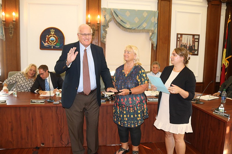 Councilman Dave Winslow, joined by his wife, Kathleen, takes the oath of office from City Clerk Melissa Rasner on Aug. 10.