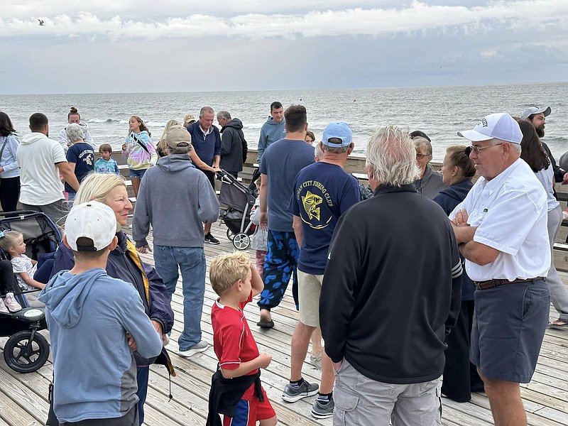 Despite clouds and a stiff breeze, visitors enjoy the tour of the Ocean City Fishing Club's pier during the open house. (Photo courtesy of Greg Borak on Facebook)