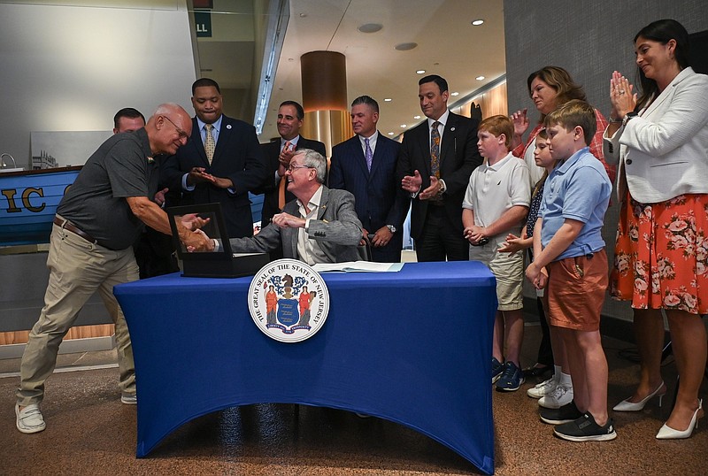 Gov. Murphy shakes hands with Assemblyman Don Guardian at the bill signing ceremony. (Photo provided)