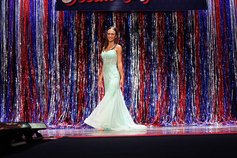 Arianna DiAntonio wears a flowy, seafoam green dress.