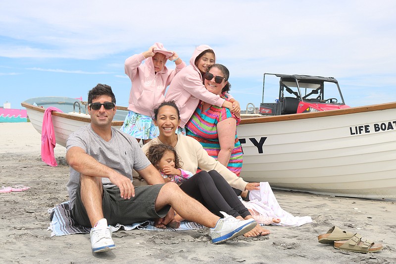 Nick and Gina Donato, of Lansdale, Pa., and his sister, Michelle Bruns and her children make the most of it despite rough surf and cooler temps.