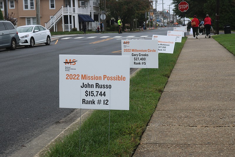 Team signs line Fifth Street toward the finish line.