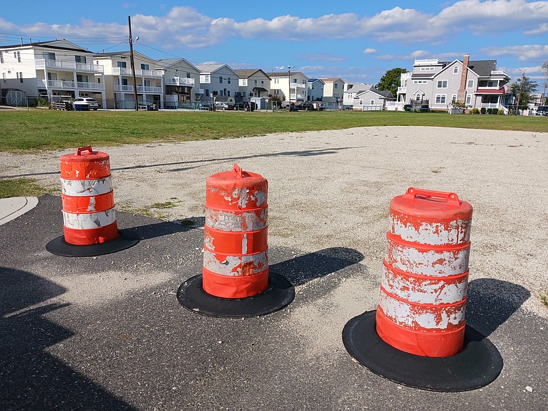 The proposed construction site, now empty land, is on the north side of Fourth Street.