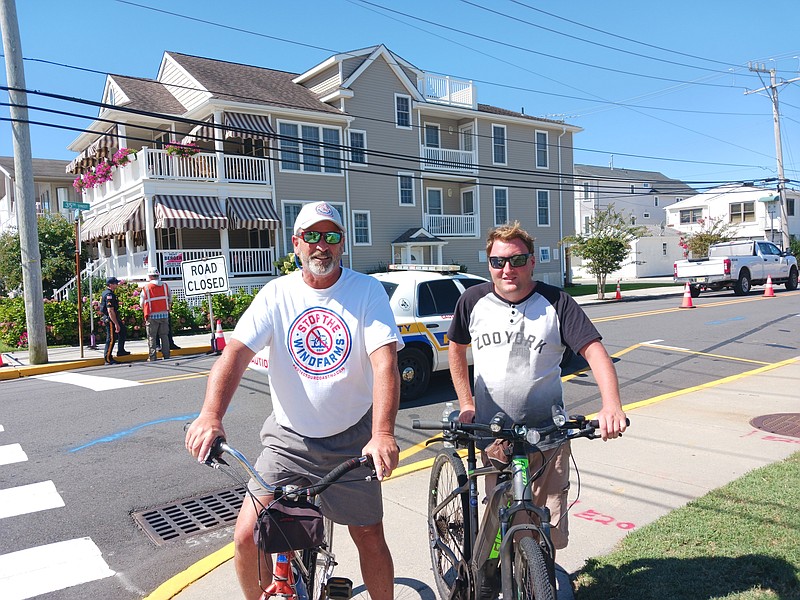 Wind farm opponents Steve Flogaus, left, and Brody Bauer attend the protest.