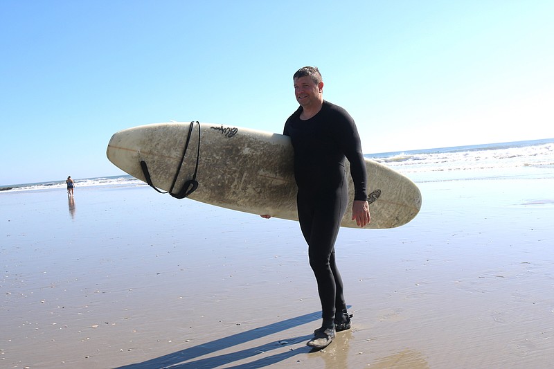 Josh Linthicum comes in after a great morning of surfing off Eighth Street.