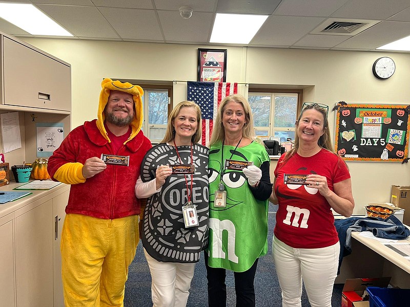 School personnel, including Principal Dr. Cathy Smith, in green, get into the spirit of the holiday. (Photo courtesy of the PTA)