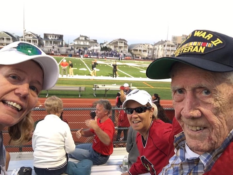 Francis with his daughter Maureen, across the table, and Kay Jacobs at an Ocean City High School Raiders football game in 2017. 