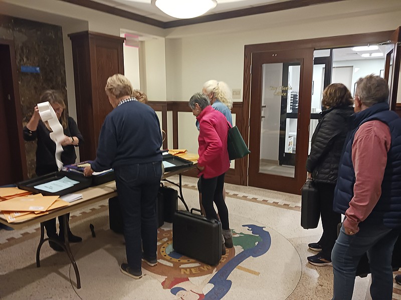 Ocean City poll workers bring in briefcases containing ballots Tuesday.