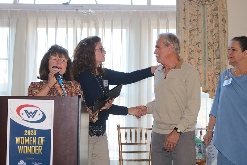 Leif Johnson accepts the honor for his late wife, Laurie Johnson. 