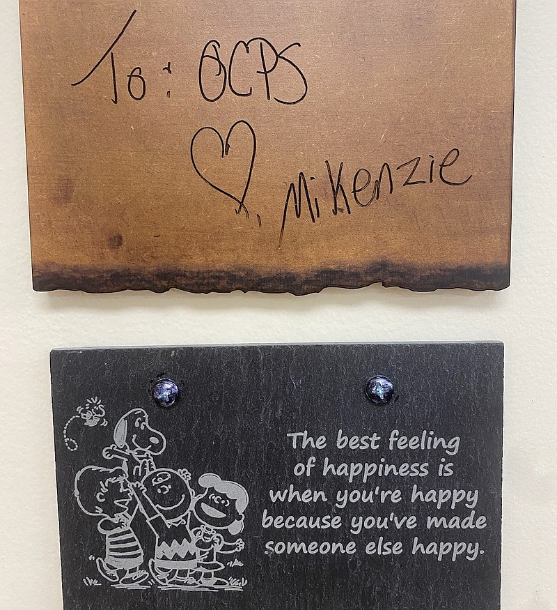 The two plaques left by Mikenzie.