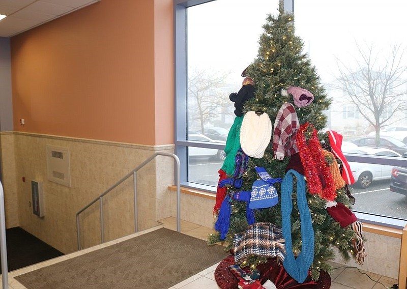 Hats, scarves and mittens adorn the tree.