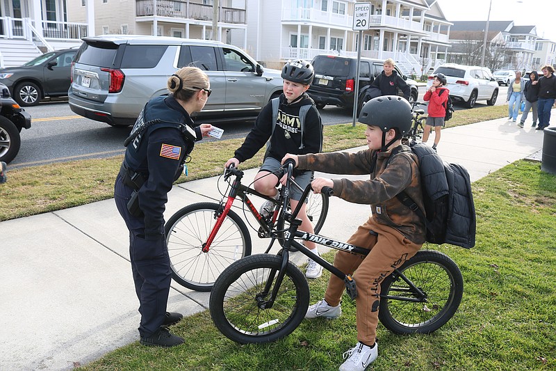 Officer Kayla Ricci talks to Ocean City Intermediate School students Jude Baltozer, left, and Carter Chorin during a police bike safety event in 2024.
