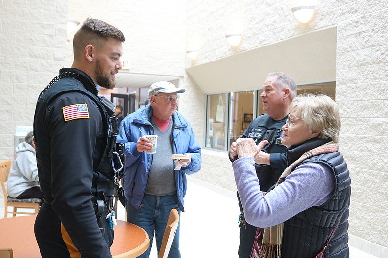 Craig and Marie Stuart, of Ocean City, speak with Officers Austin Ogule, left, and Mike Gray.