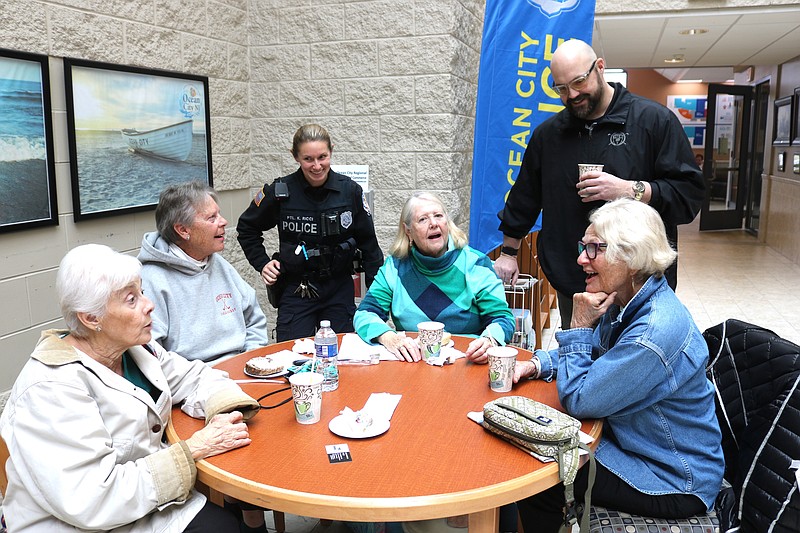 Police Officers Kayla Ricci and Jack Davis speak with Noreen Spraga, Beth Pasternak, Marian Mulligan and Robin Peterson during a "Coffee With Cops" in 2024.