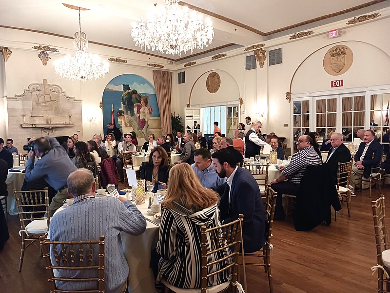 An audience fills the ballroom at The Flanders Hotel.