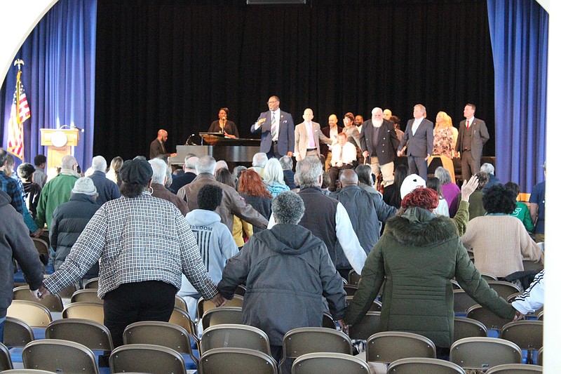 An audience listens to the service. 