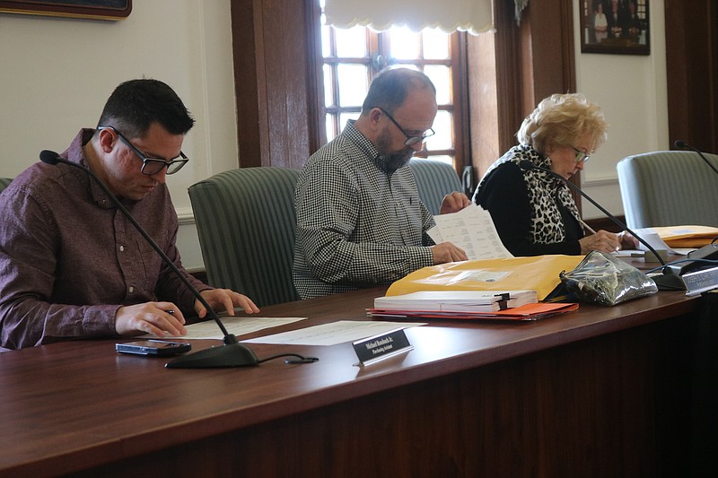 From left, Purchasing Assistant Michael Rossbach Jr., Purchasing Manager Joe Clark and Deputy City Clerk Sheila Cottrell review documents during the bid opening. 