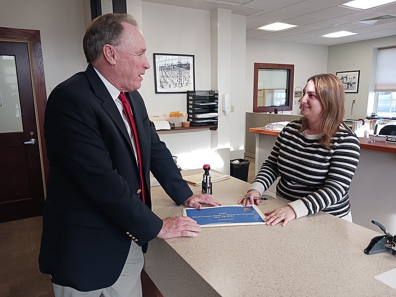 At-Large Council candidate Sean Barnes submits his nominating petitions to City Clerk Melissa Rasner.