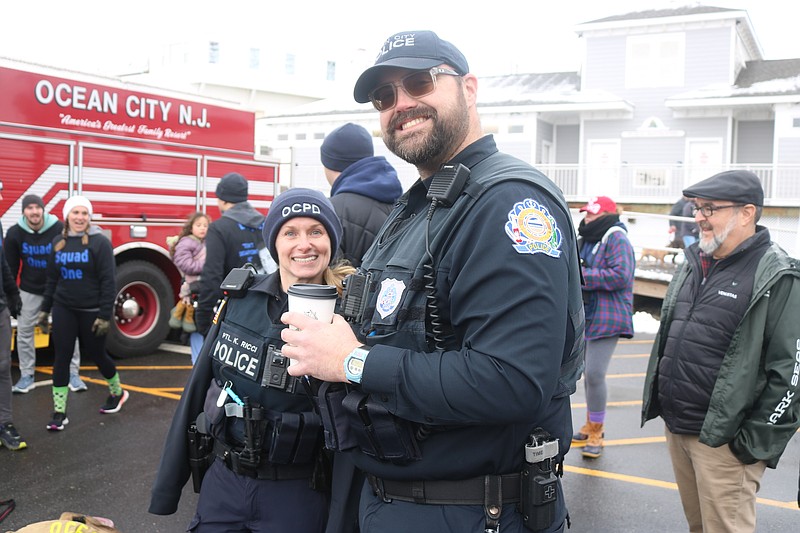 Officers Kayla Ricci and Jack Davis cheer on their fellow officers.