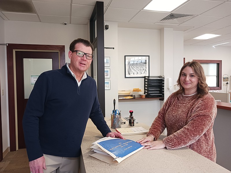 Council At-Large candidate Mike DeVlieger hands in his nominating petitions to City Clerk Melissa Rasner.