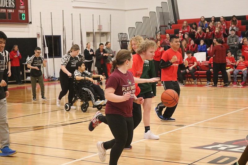 An Ocean City Unified Sports basketball team player dribbles the ball down court during the Feb. 29 tourney.