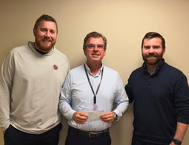 David Hughes, president of Shore Medical Center, center, accepts the donation from David Beyel Jr., left, and Jason Dugan on behalf of the non-profit organization. (Photo courtesy of Shore Medical Center)